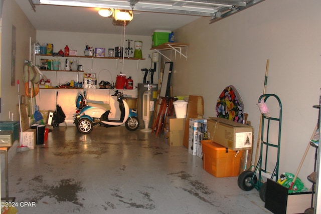 garage with electric water heater and a garage door opener