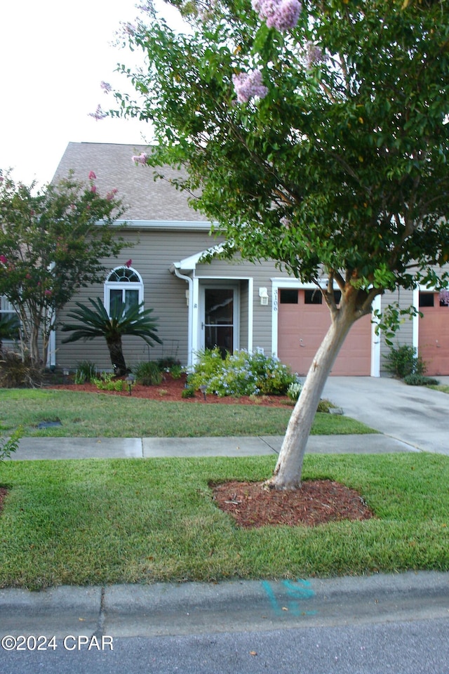 view of front of house with a garage and a front yard