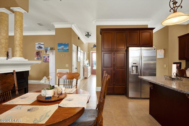 dining space with crown molding, ornate columns, and light tile patterned floors