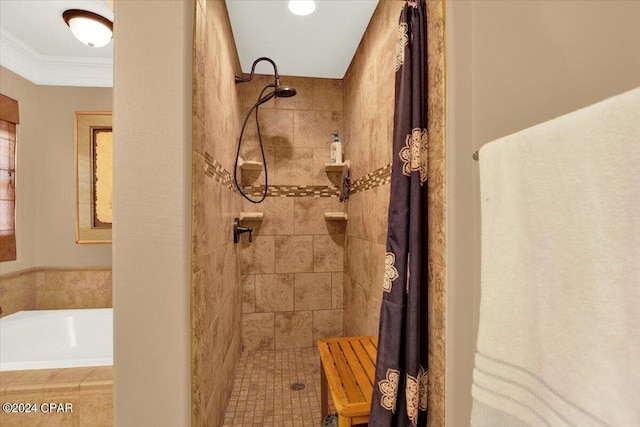 bathroom with shower with separate bathtub and ornamental molding