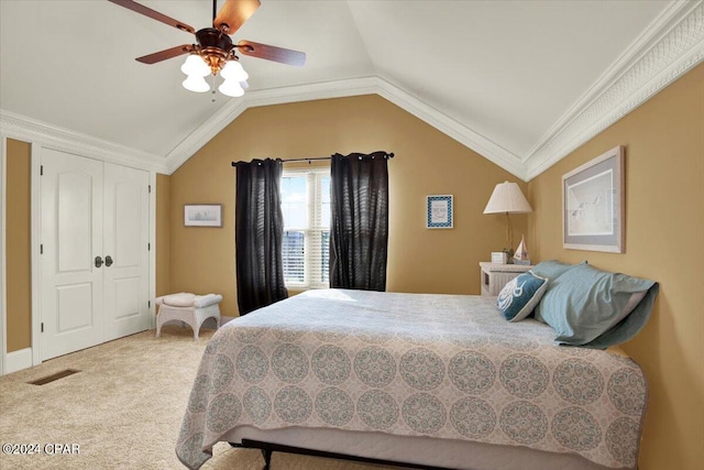 bedroom featuring ceiling fan, vaulted ceiling, ornamental molding, and carpet