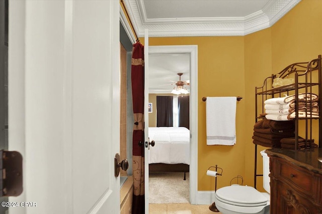 bathroom featuring ceiling fan, crown molding, and toilet