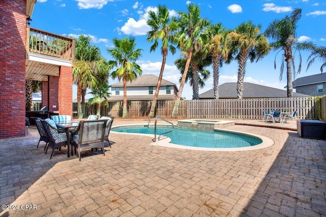 view of swimming pool featuring an in ground hot tub and a patio area