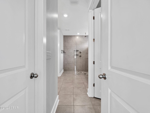 bathroom featuring a tile shower and tile patterned floors