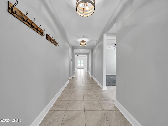 hall with light tile patterned floors