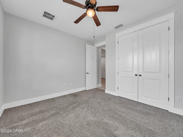 unfurnished bedroom featuring carpet flooring, a closet, and ceiling fan