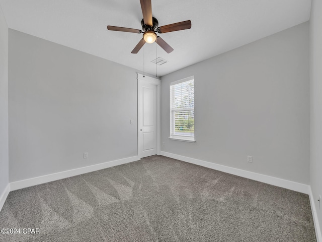 carpeted empty room with ceiling fan