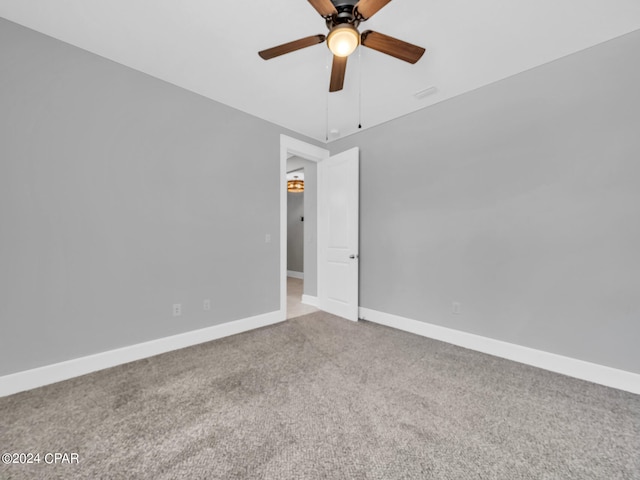 spare room featuring carpet and ceiling fan