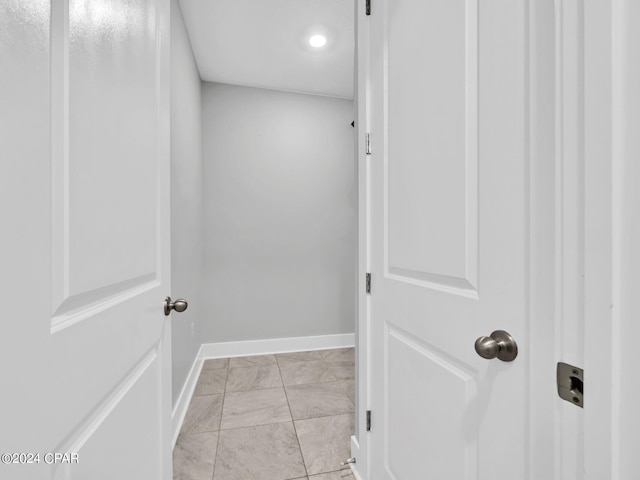 clothes washing area featuring light tile patterned floors