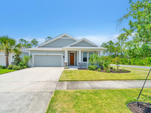 view of front facade featuring a front yard and a garage