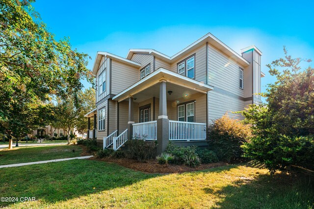 view of front facade with a front lawn and a porch