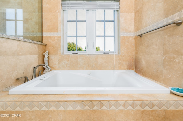 bathroom with a relaxing tiled tub