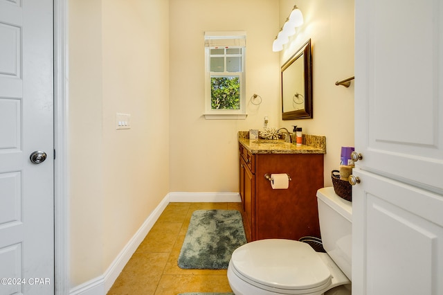 bathroom featuring vanity, tile patterned flooring, and toilet