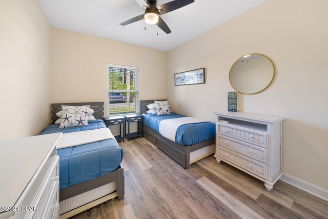 bedroom with ceiling fan and hardwood / wood-style flooring