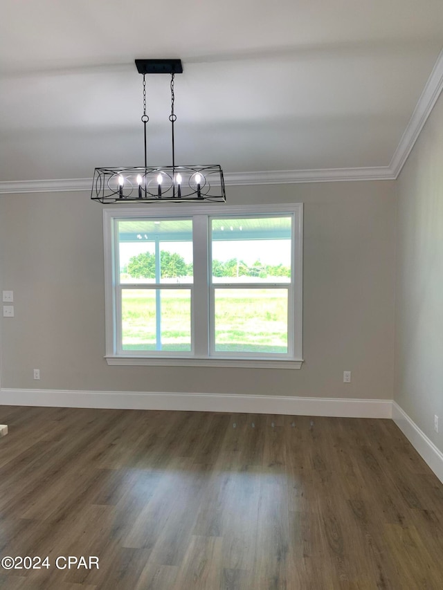 unfurnished dining area with dark hardwood / wood-style flooring, a notable chandelier, and ornamental molding