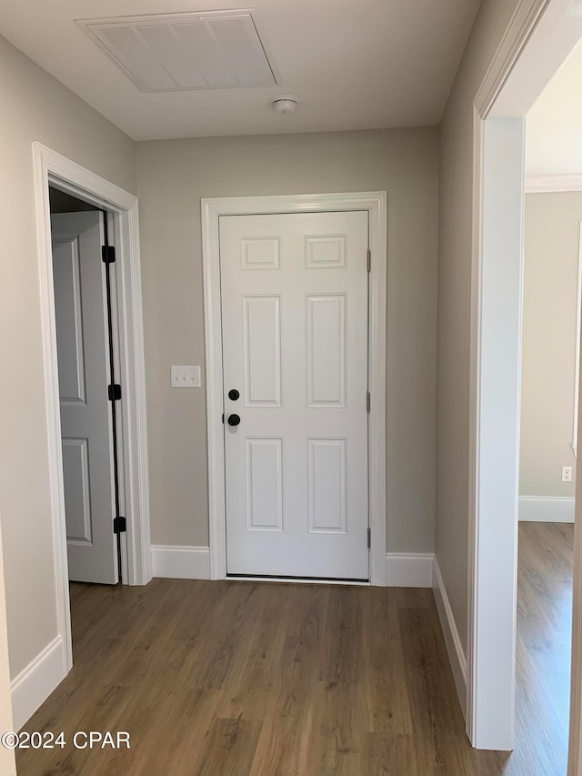 hall with wood-type flooring