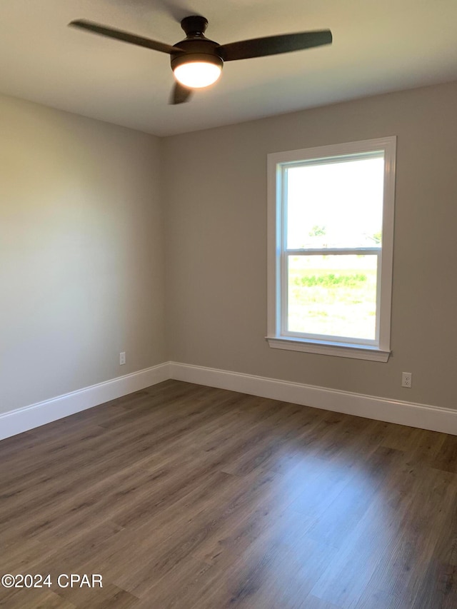 spare room with ceiling fan and dark hardwood / wood-style floors