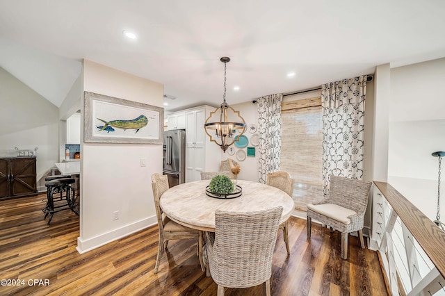 dining area featuring dark wood-type flooring and a chandelier