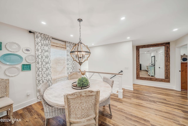 dining area with a chandelier and light wood-type flooring