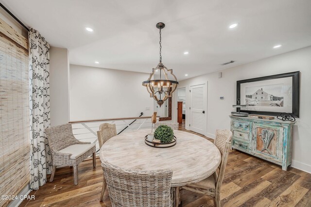 dining room featuring an inviting chandelier and light wood-type flooring