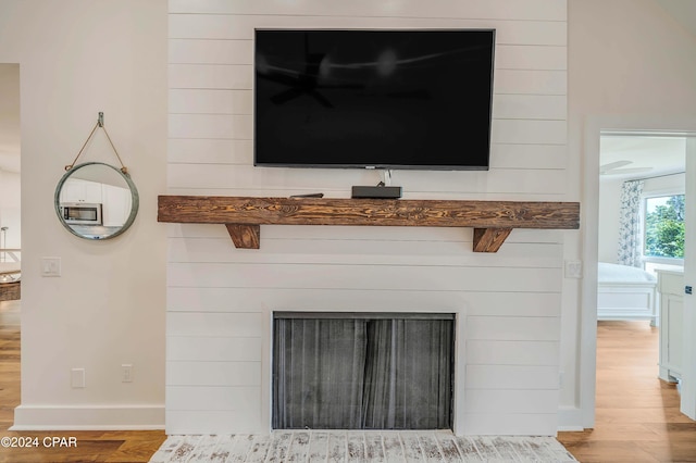 interior details featuring hardwood / wood-style flooring and a fireplace