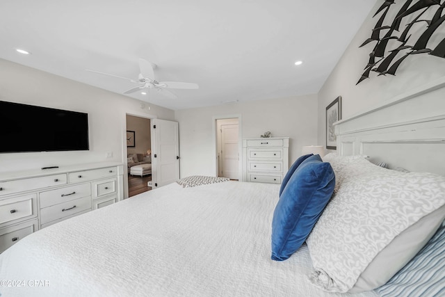 bedroom with hardwood / wood-style flooring, ensuite bathroom, and ceiling fan