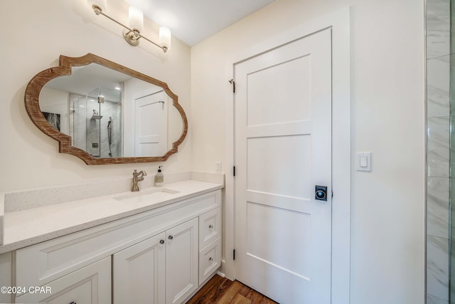 bathroom featuring an enclosed shower, vanity, and hardwood / wood-style flooring