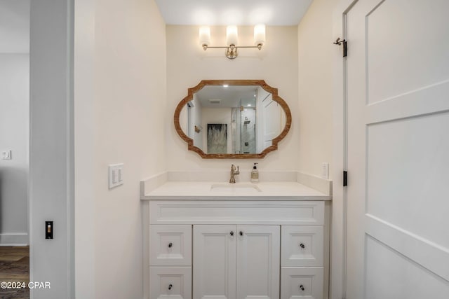 bathroom featuring hardwood / wood-style flooring and vanity