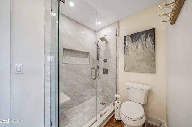 bathroom with walk in shower and toilet