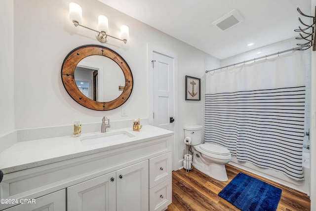 full bathroom with wood-type flooring, toilet, shower / tub combo, and vanity