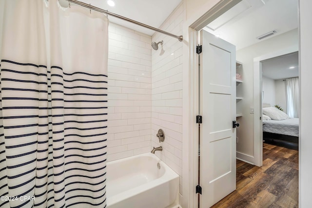 bathroom with wood-type flooring and shower / bath combo