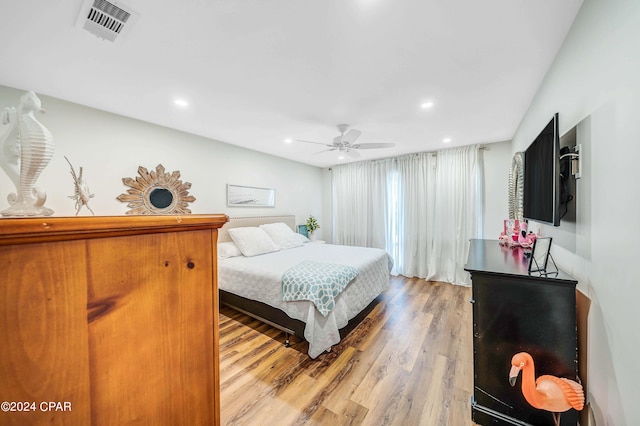 bedroom with wood-type flooring and ceiling fan