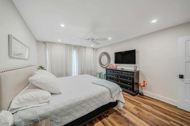 bedroom featuring hardwood / wood-style floors and ceiling fan