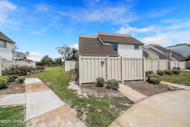 view of property exterior with a yard