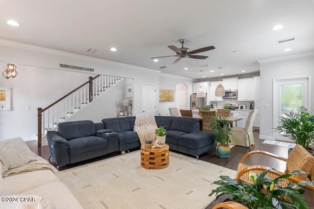 living room with stairway, a ceiling fan, wood finished floors, recessed lighting, and crown molding