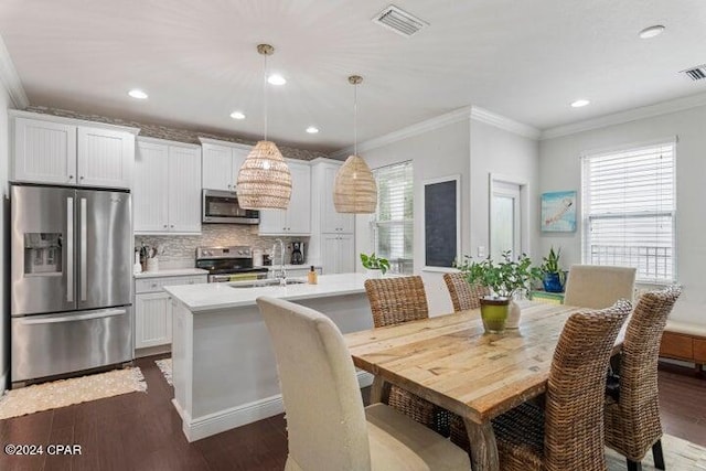 dining room with visible vents, recessed lighting, dark wood-type flooring, and ornamental molding