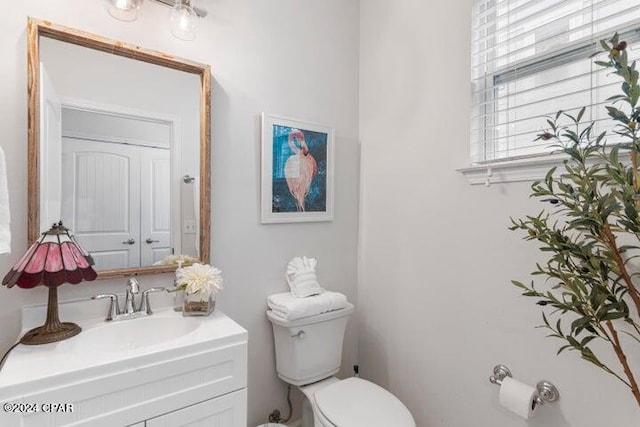 bathroom featuring toilet and vanity