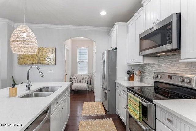 kitchen with appliances with stainless steel finishes, light countertops, and a sink