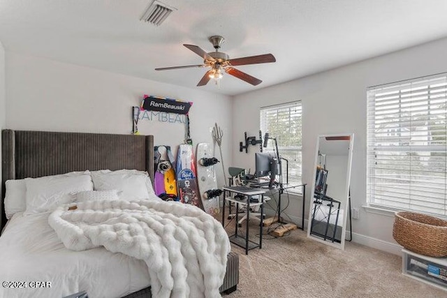 bedroom with visible vents, baseboards, carpet, and a ceiling fan