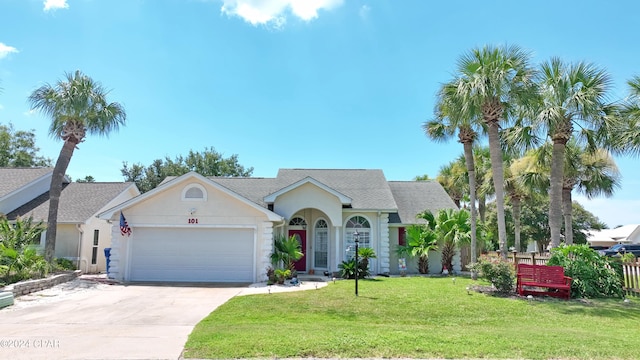 view of front of house with a front yard and a garage