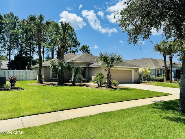 ranch-style home with driveway, a garage, fence, a front lawn, and stucco siding