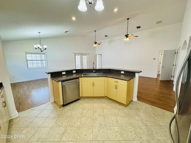 kitchen with light tile patterned floors, dark countertops, open floor plan, stainless steel appliances, and a sink