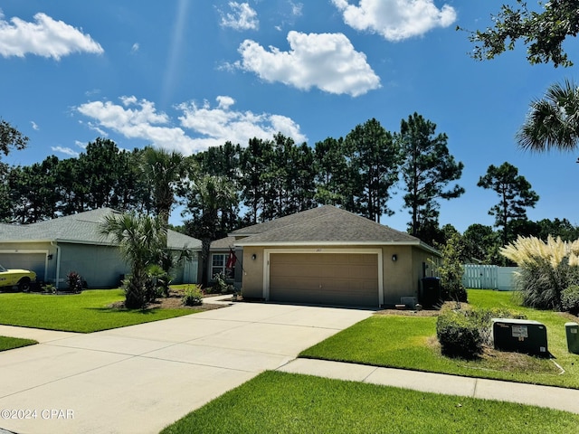 ranch-style home with a garage, concrete driveway, fence, a front lawn, and stucco siding