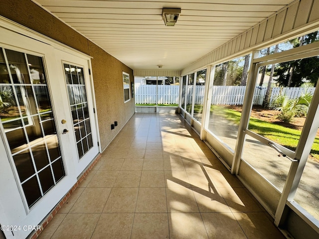 unfurnished sunroom with wood ceiling