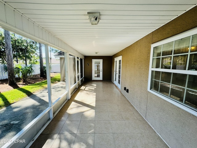 unfurnished sunroom with french doors