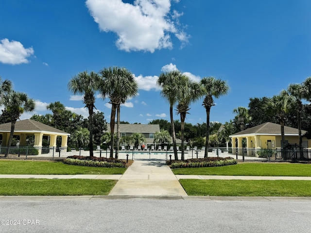 surrounding community featuring a yard, fence, and a swimming pool