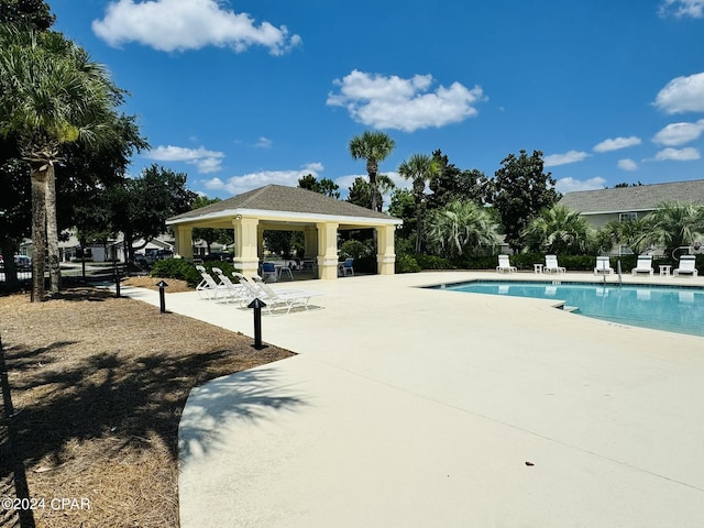 community pool featuring a gazebo and a patio area