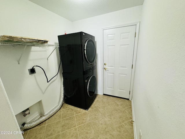 laundry room with light tile patterned floors, laundry area, and stacked washing maching and dryer