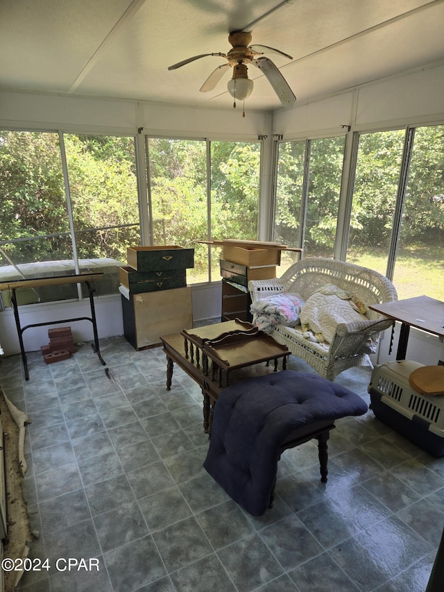 sunroom / solarium featuring a wealth of natural light and ceiling fan