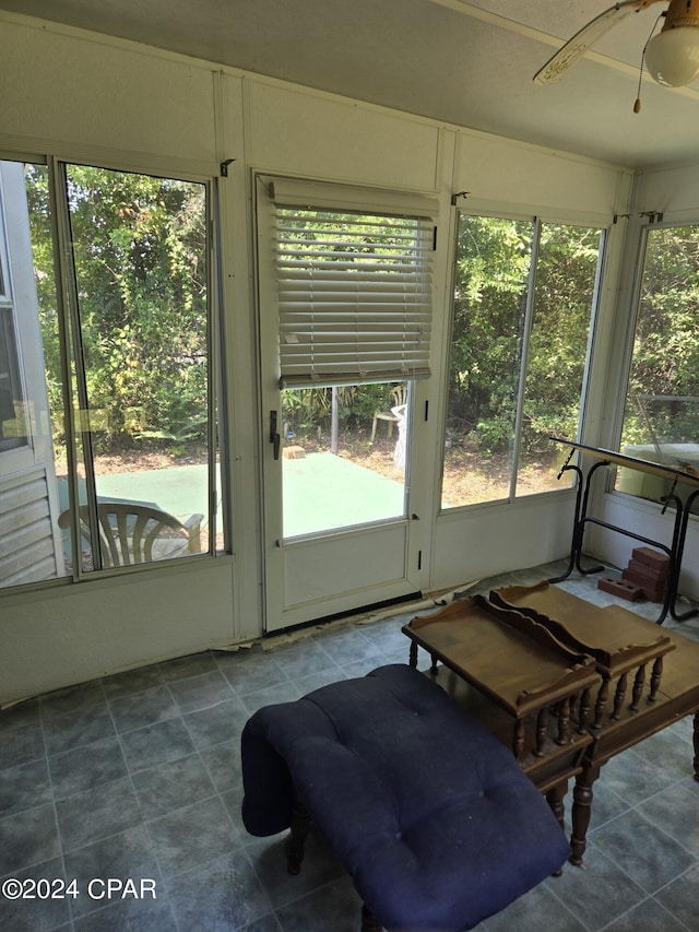 sunroom / solarium featuring ceiling fan